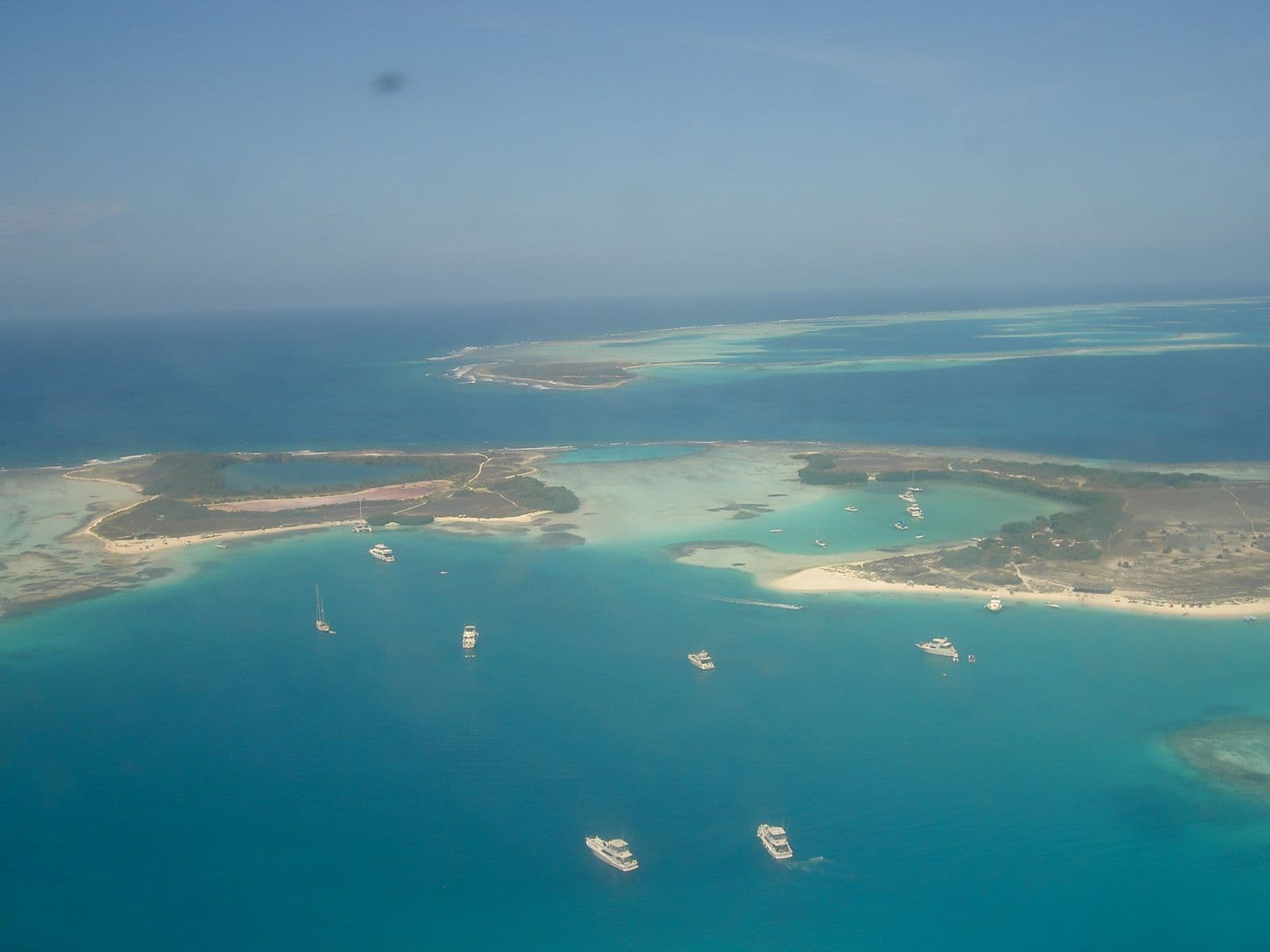 Aerial view of the Francisquí cays, in Los Roques, surrounded by turquoise water with anchored boats